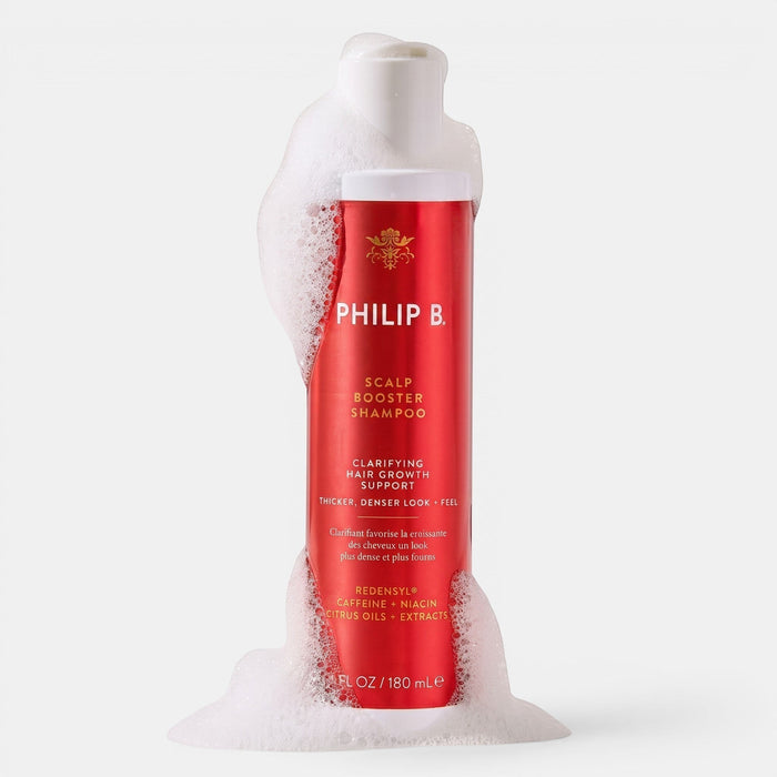Shop Rescue Spa Philip B. Scalp Booster Shampoo in a red bottle covered in white cleansing foam
