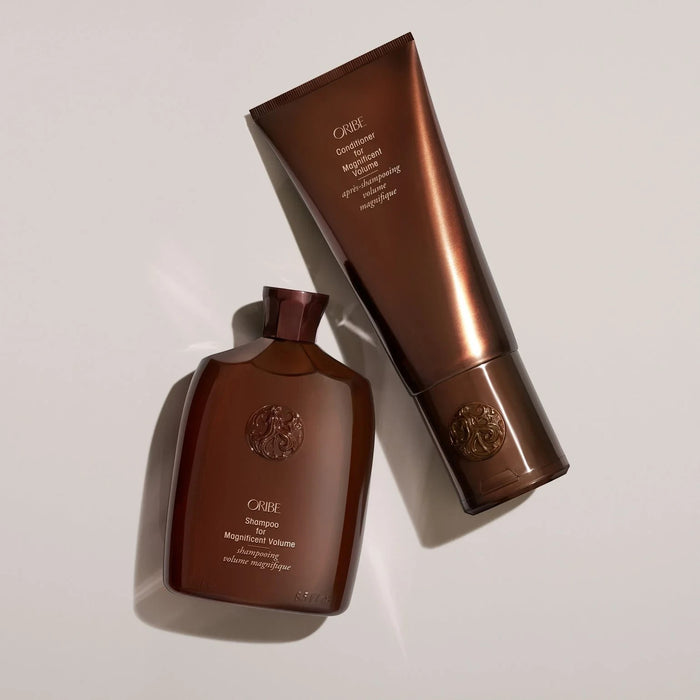Shop Rescue Spa Oribe Shampoo and Conditioner for Magnificent Volume in signature brown bottles on a neutral background