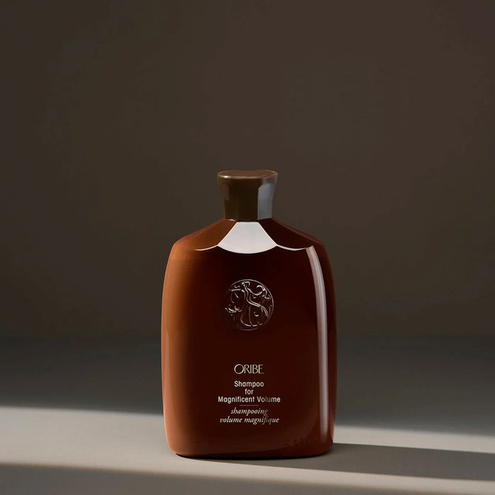 Shop Rescue Spa Oribe Shampoo for Magnificent Volume in a sleek brown bottle for hair thickness and body.