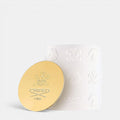 Shop Rescue Spa Silver Mountain Water candle in a white embossed ceramic jar with a gold lid featuring the Creed logo.