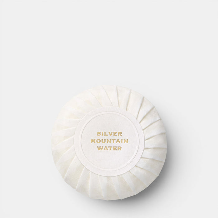 Shop Rescue Spa Silver Mountain Water round white perfumed cleansing bar with gold embossed text