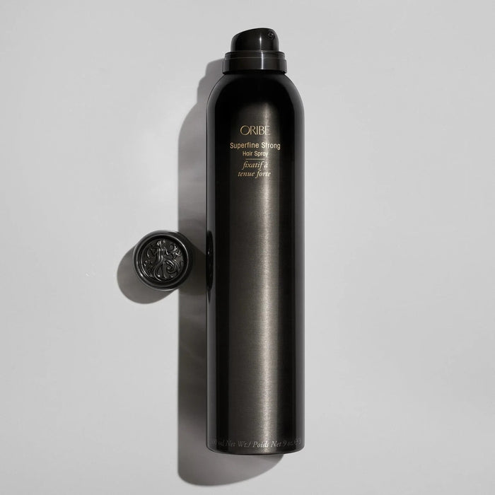 Shop Rescue Spa ORIBE Superfine Strong Hair Spray bottle with ornate cap, providing strong hold and natural shine.