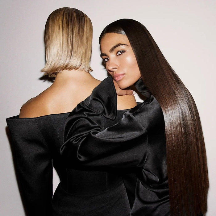 Shop Rescue Spa Supershine Light Moisturizing Cream on models with sleek, shiny hair. One model has dark brown hair, the other blonde.