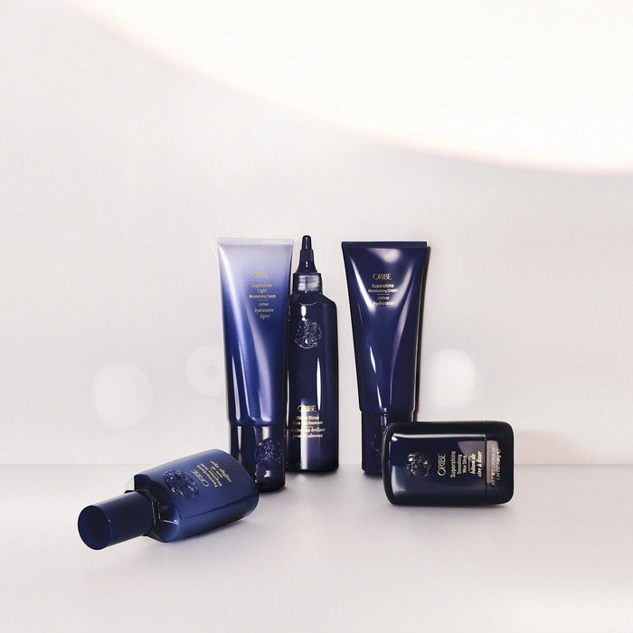 Shop Rescue Spa Oribe Supershine Light Moisturizing Cream in a blue tube, with other Oribe hair products.