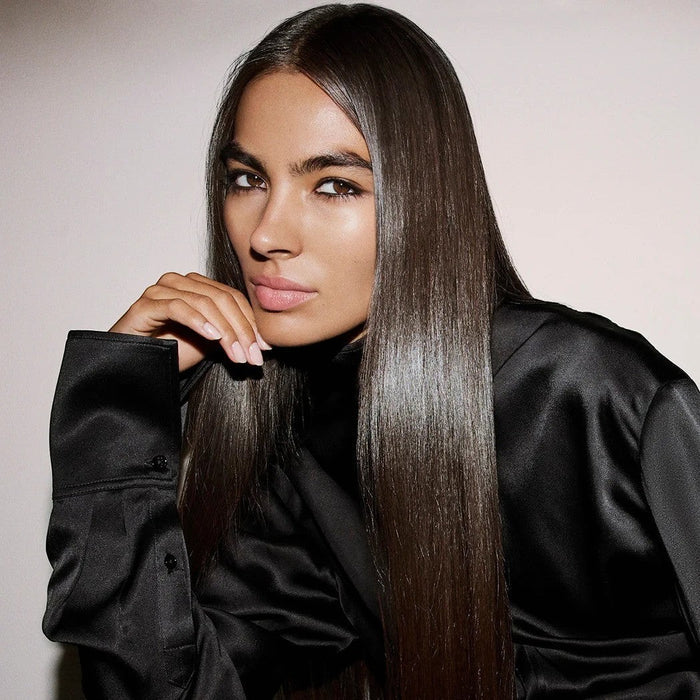 Shop Rescue Spa Supershine Moisturizing Cream model with long, sleek, high-shine dark hair in a black silk shirt