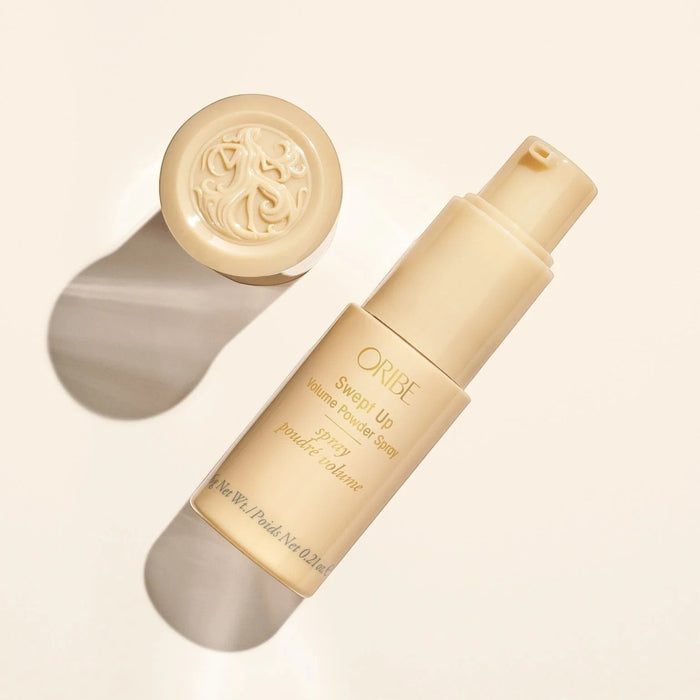 Shop Rescue Spa Oribe Swept Up Volume Powder Spray for weightless lift and texture. Beige bottle with gold lettering.