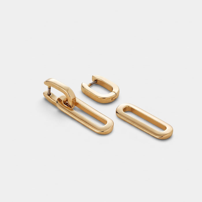 Shop Rescue Spa 14k gold dipped brass huggie earrings with detachable oval link charms in a high polish finish.