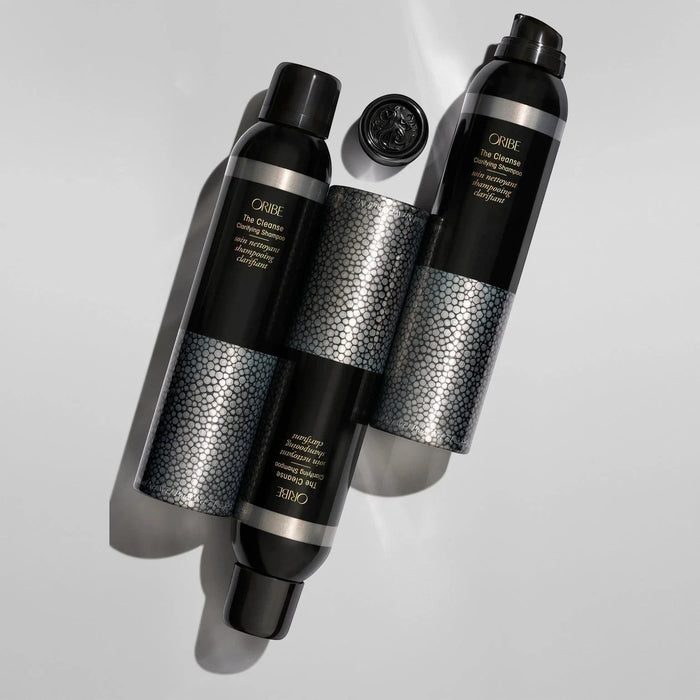 Shop Rescue Spa Oribe The Cleanse Clarifying Shampoo bottles with textured silver bands and black caps.