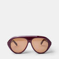 Product photo of Past Midnight The Icon Sunglasses in burgundy on a white background, positioned at the bottom of the frame with arms open, showing full frame shape.
