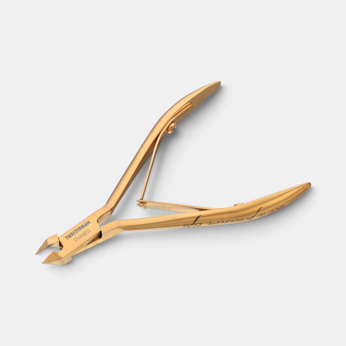 Tweezerman Ultra Precision Nipper in gold titanium-coated stainless steel for cuticle trimming.