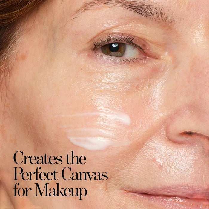 Shop Rescue Spa Ultra Sun Protection SPF 45 primer applied as a smooth white cream on a woman's cheek.