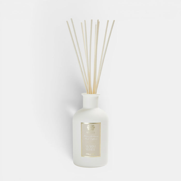 Shop Rescue Spa Antica Warm White reed diffuser in a frosted white apothecary vessel with natural rattan reeds.