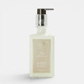 Shop Rescue Spa Warm White hand and body moisturizer in a square glass bottle with a silver pump dispenser.