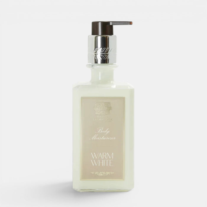 Shop Rescue Spa Warm White hand and body moisturizer in a square glass bottle with a silver pump dispenser.