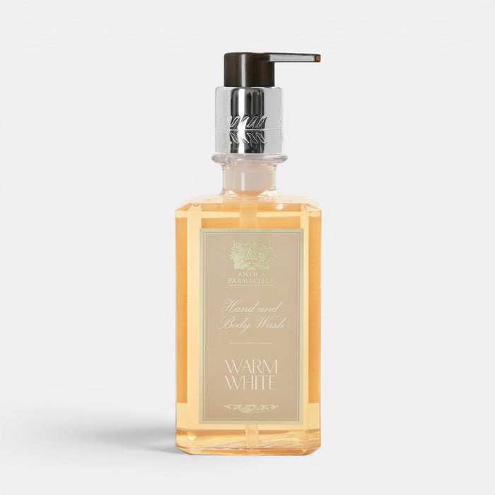 Shop Rescue Spa Warm White hand and body wash in a clear rectangular bottle with a silver pump dispenser.